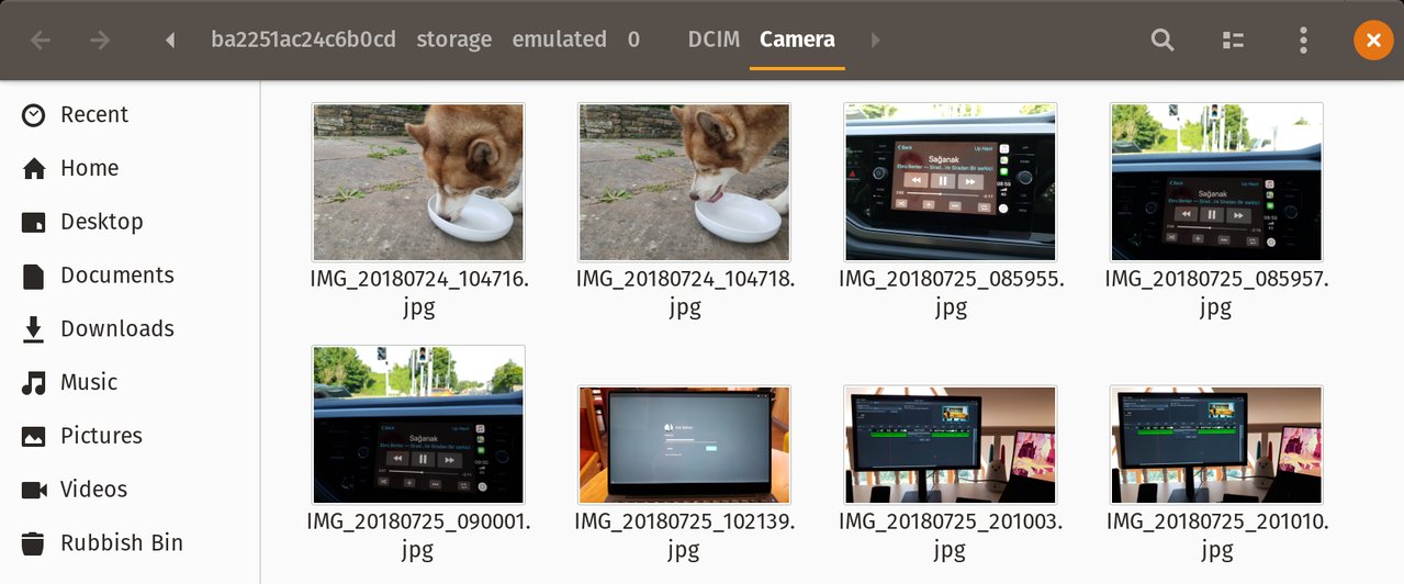 Thumbnails of the photos on my phone being displayed in Gnome Files on my desktop. The location bar reads (a hash code)/storage/emulated/0/DCIM/Camera.